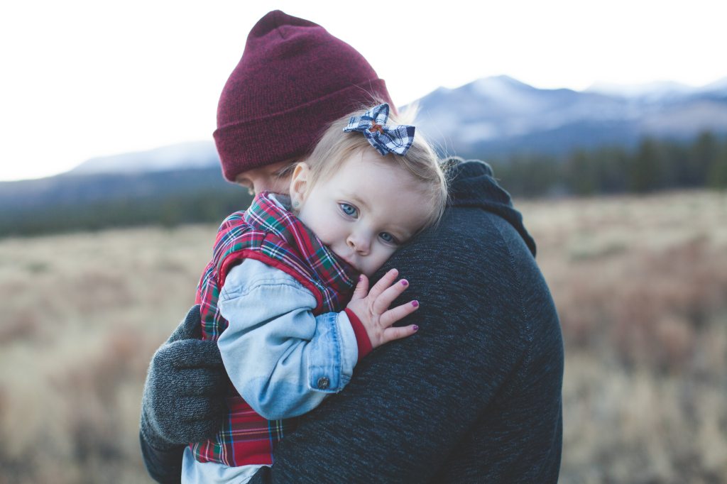 Father Hugging Young Daughter Outside