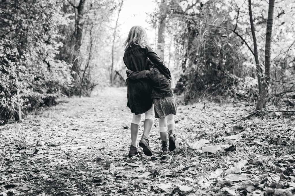 Two Little Girls Walk Down Path