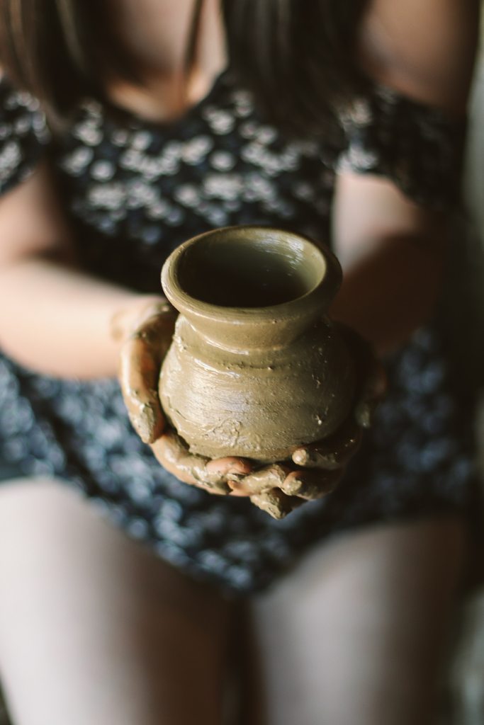Woman Holding a Clay Pot