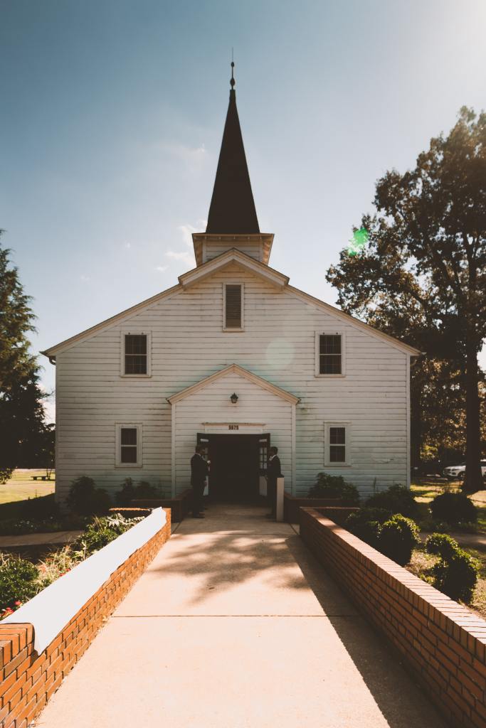 White Church Building and People Outside It