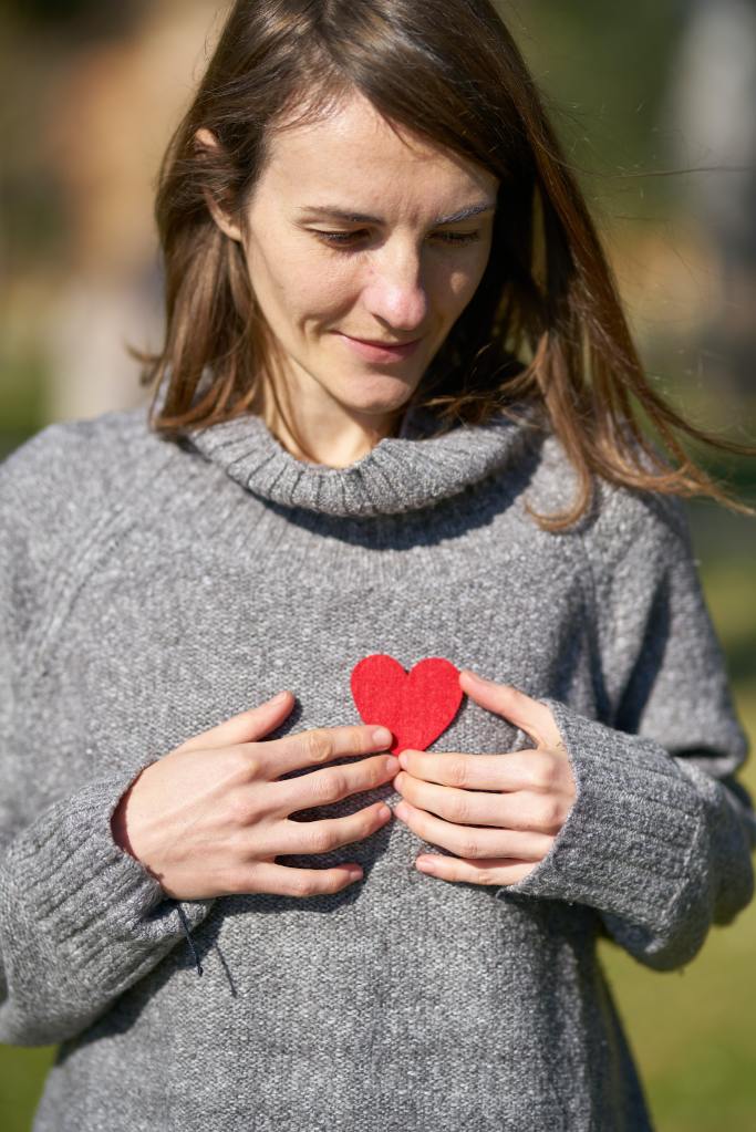 Woman Holding a Red Heart